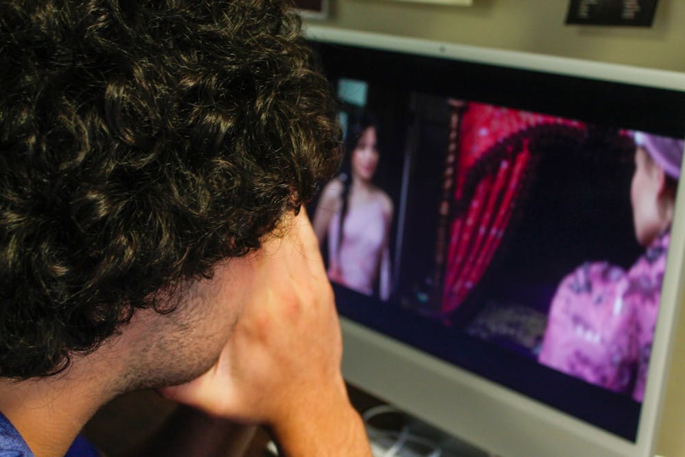 City and State Editor, Guillermo Molero, covers his face in disgust as he watches the new movie, Cinderella.