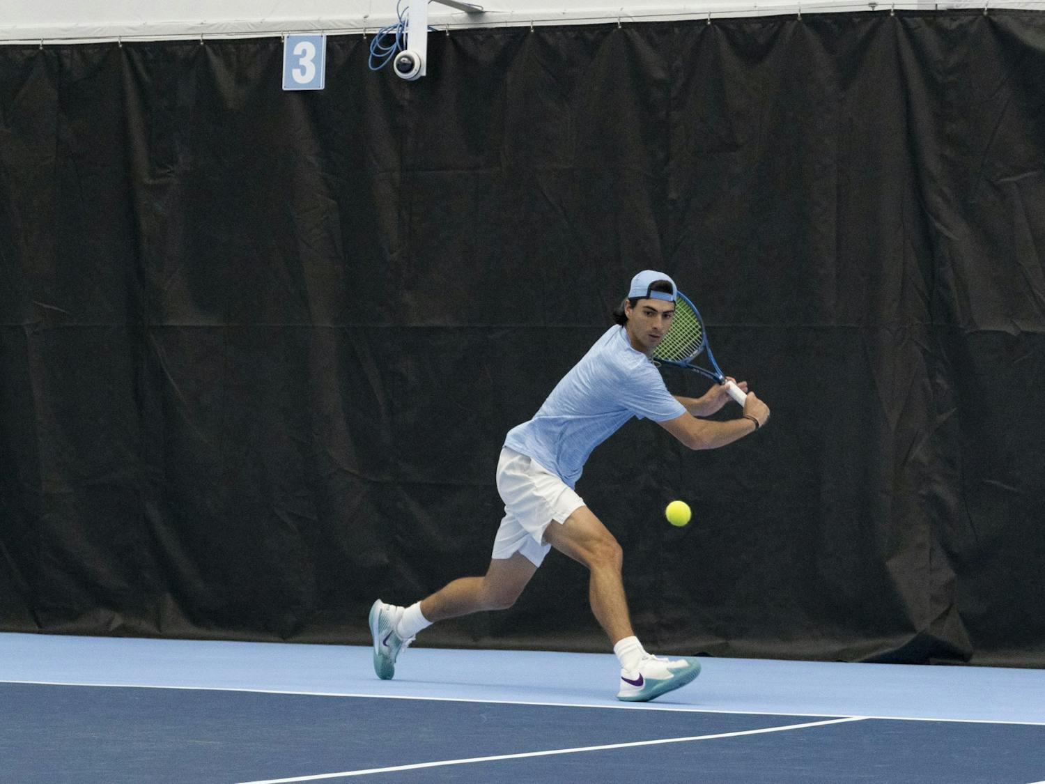 UNC junior tennis player Logan Zapp goes to take a hit at the ball during the home matchup against Duke at Cone-Kenfield Tennis Center on Saturday, April 8, 2023. UNC fell to Duke 5-2.
