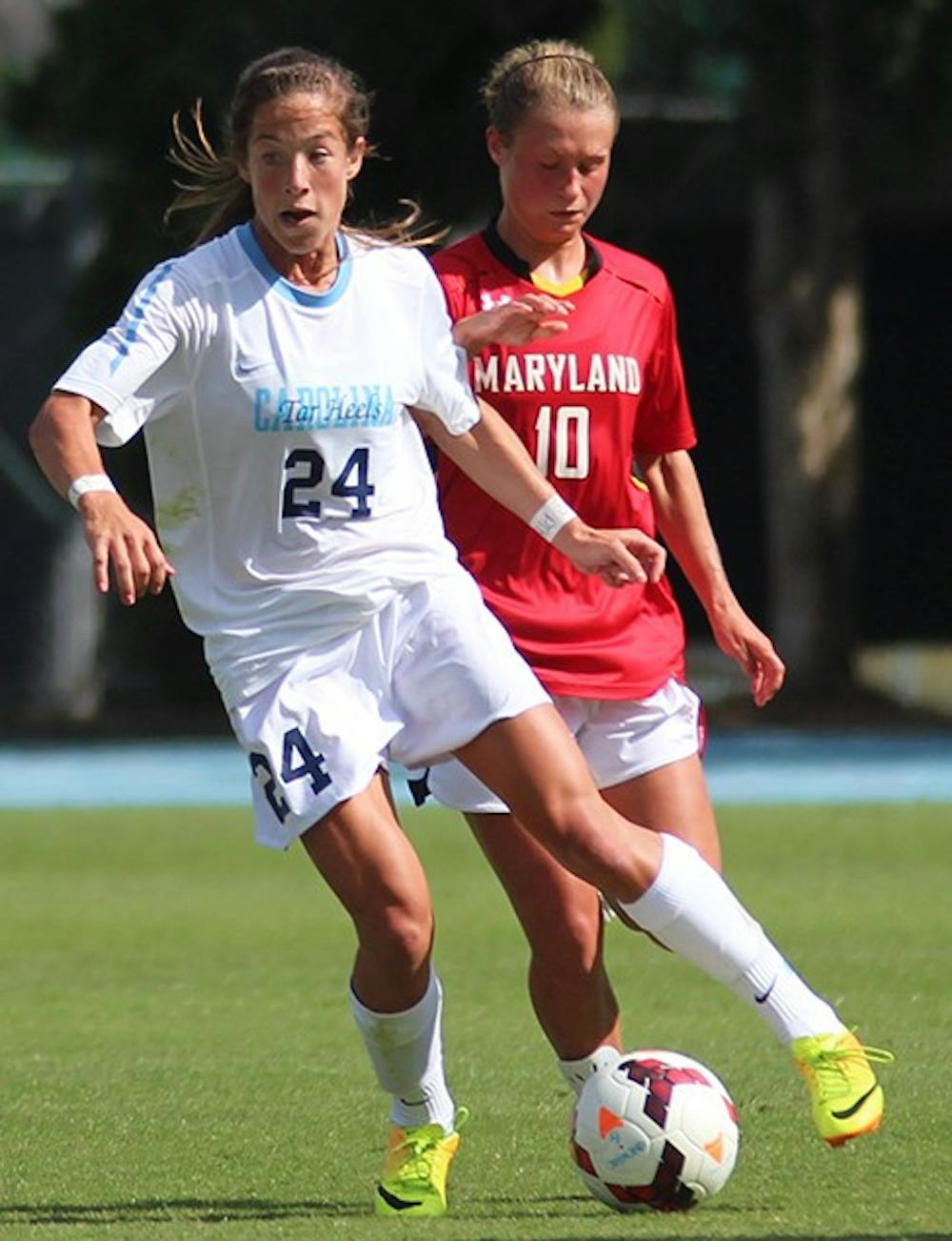 	Sophomore forward Paige Nielsen dribbles the ball away from Maryland defender. She assisted on UNC’s third goal of the day, scored by Satara Murray Sunday.