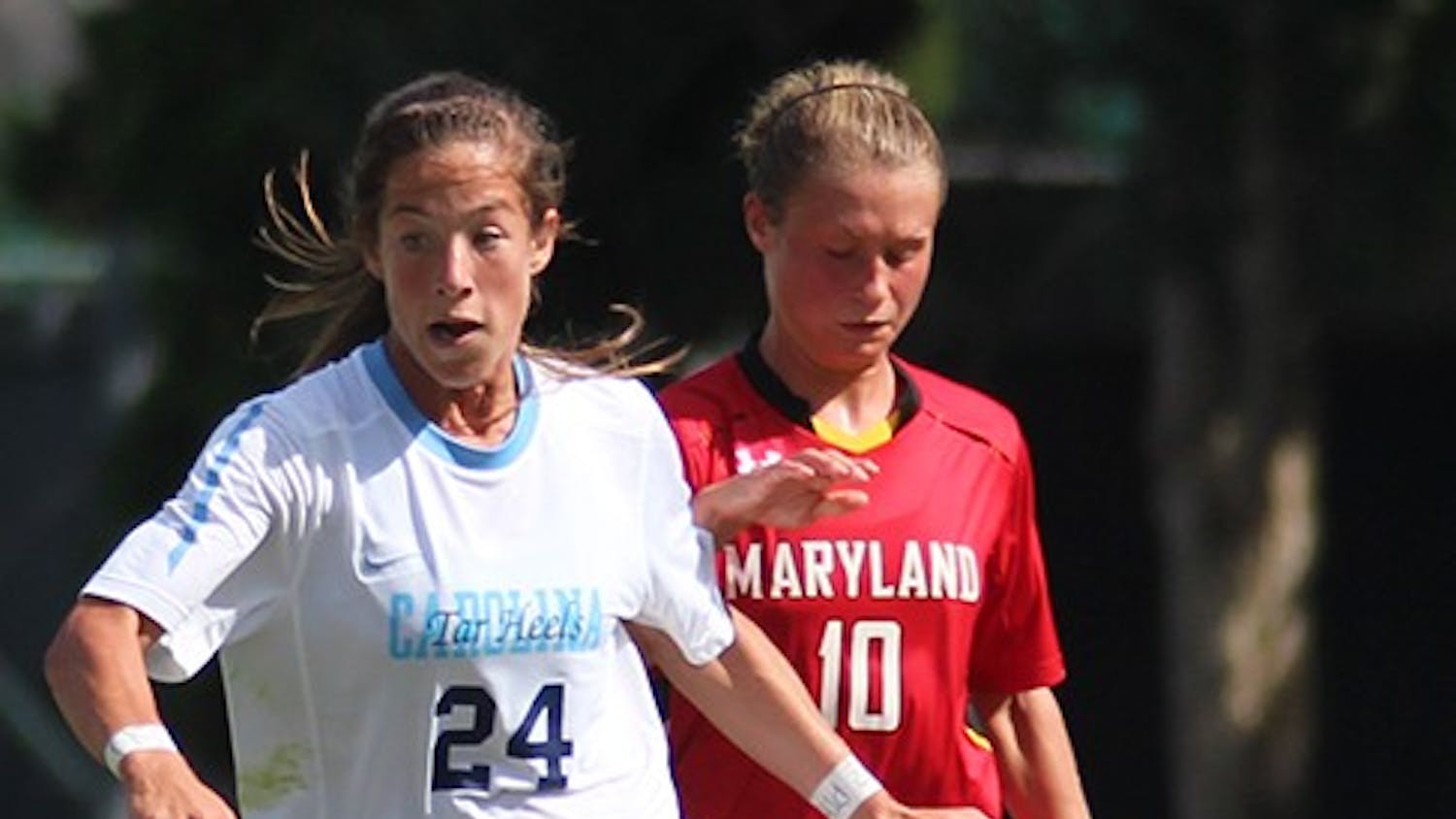 	Sophomore forward Paige Nielsen dribbles the ball away from Maryland defender. She assisted on UNC’s third goal of the day, scored by Satara Murray Sunday.