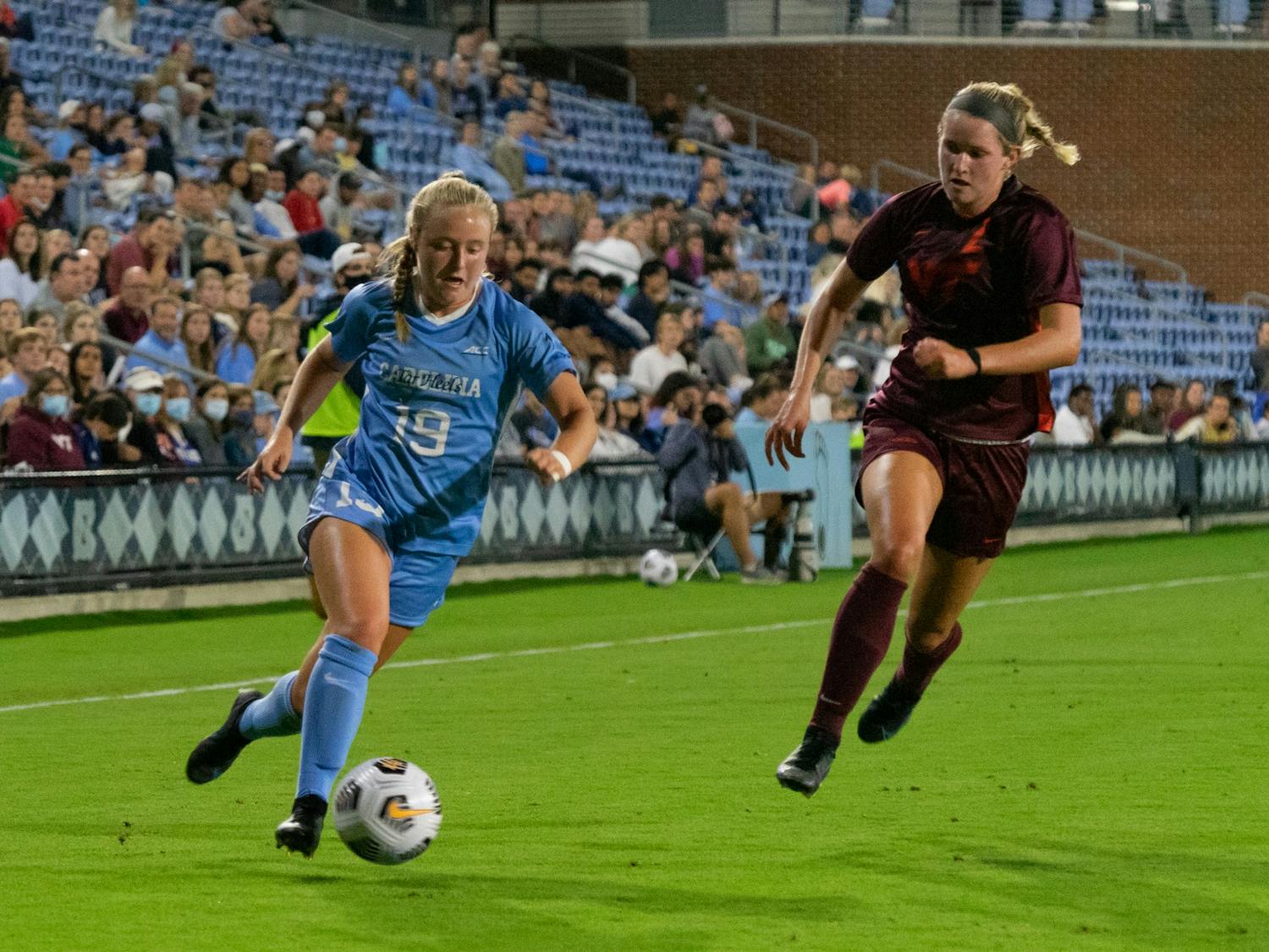 UNC first-year midfielder Emily Colton (19) runs with the ball at the game against Virginia Tech on Sept. 23 at Dorrance Field.