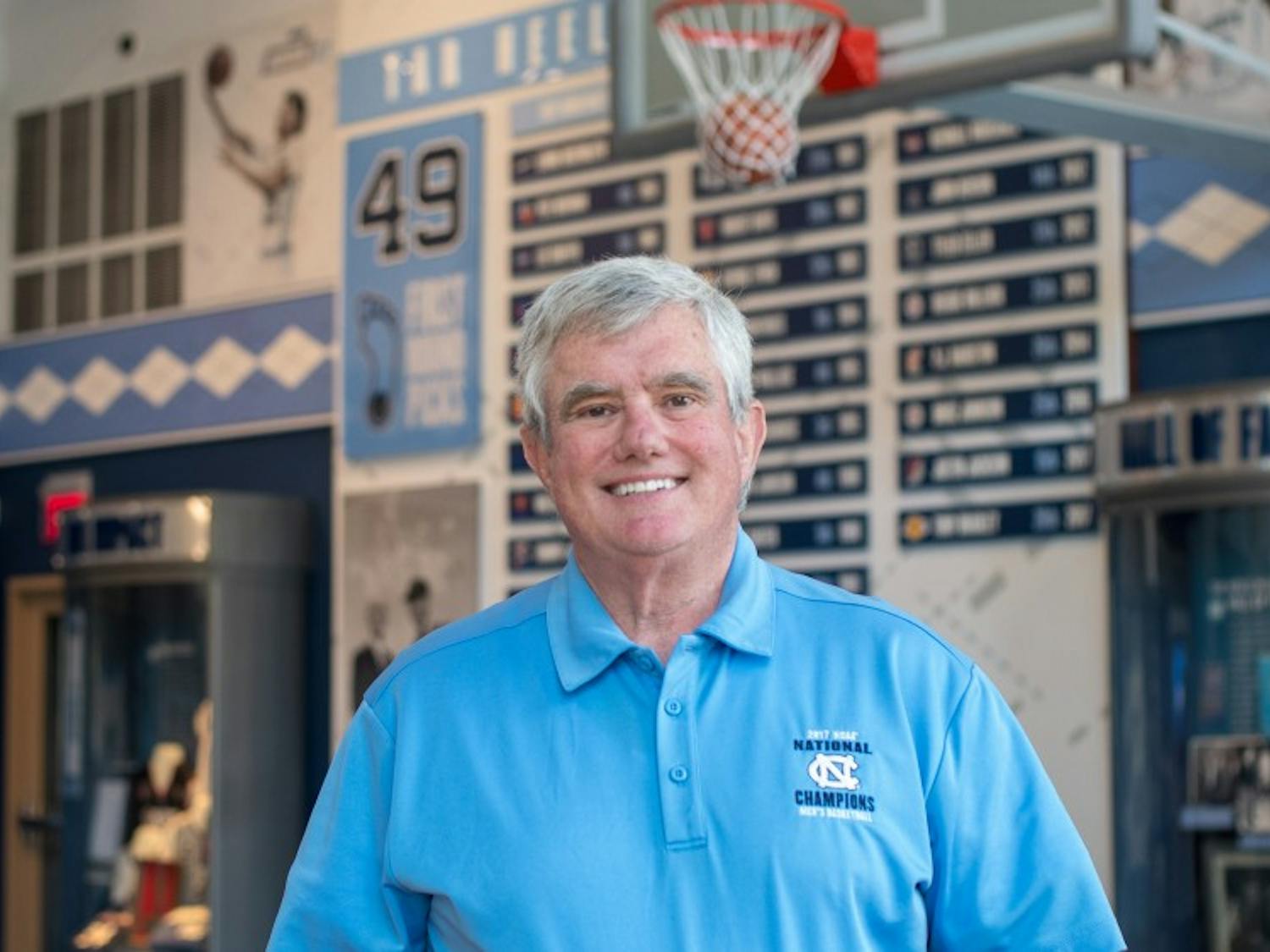 Bob Ward stands inside the Carolina Basketball Museum where he has worked as an attendant and greeter since 2008. Ward is a lifelong resident of Chapel Hill and has been a regular usher at UNC basketball games for 35 years.