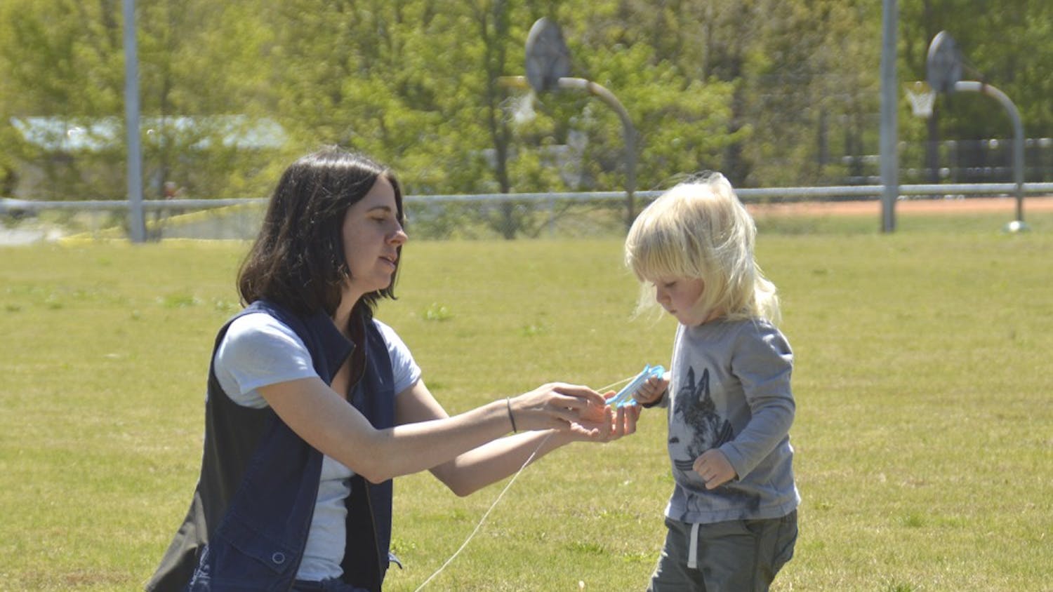 Carrboro Kite Fly takes place on Sunday Apr.17  from 1PM to 3 PM at Hank Anderson Park. 

Andrea Wood (left) from Carrboro is teaching her two-year-old son Rye Jones(right) to fly a kite. 