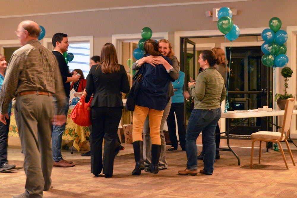 Jessica Anderson hugs a friend after being elected Town Council at the CHALT election party.