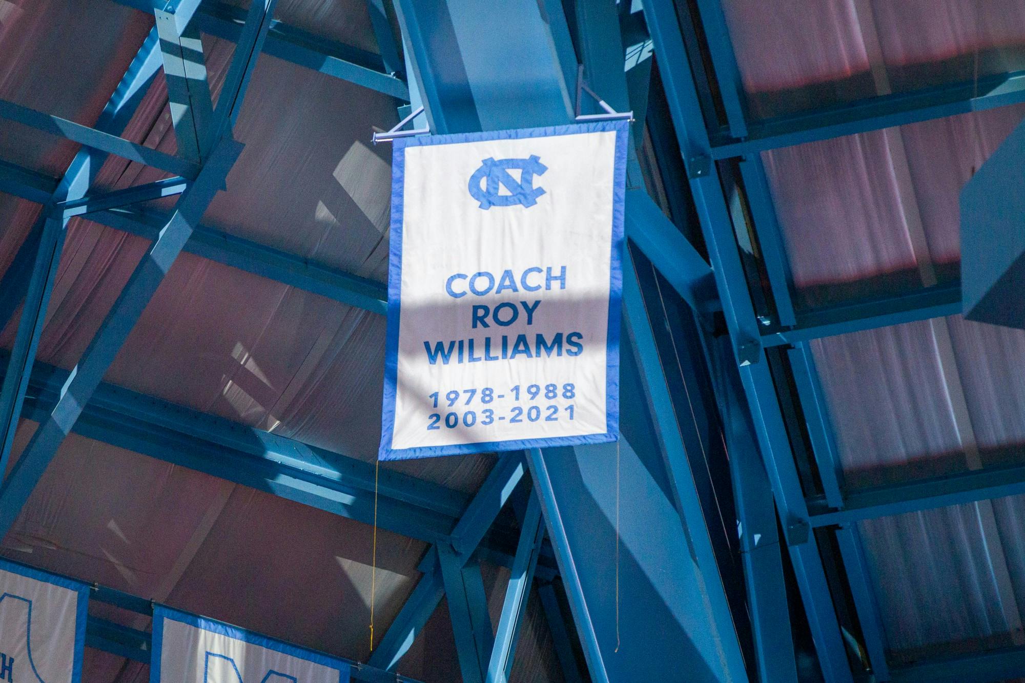 Former head coach Roy Williams and the 1982 Championship team