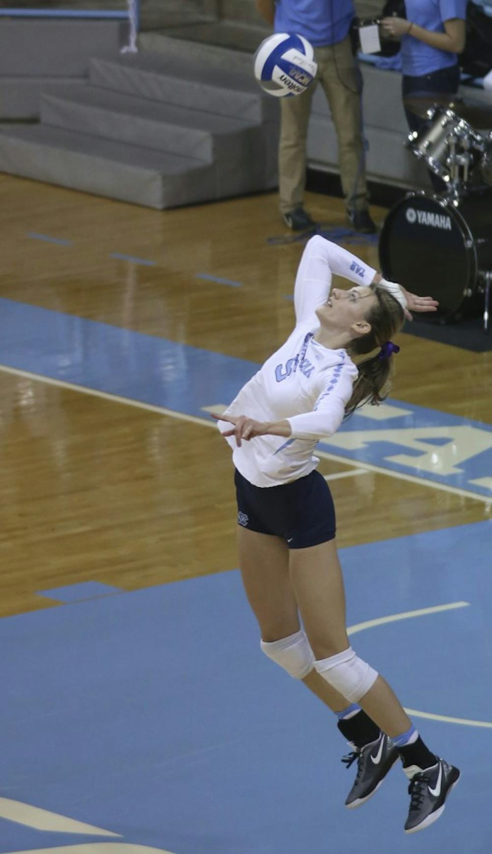 Junior Taylor Fricano (5) goes up for a serve Friday night against UVA.