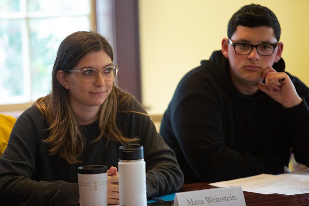 Law student Maya Weinstein (left) and student Joshua Romero, members of the Campus Safety Commission, listen to remarks during a meeting in Carroll Hall on Wednesday, Jan. 15, 2020, ahead of the Summit of Safety and Belonging. "I really feel like they created this mostly, and it’s not us giving feedback and listening more and putting the Chancellor in the hot seat,” Weinstein said. “It does feel more of like a presentation and parade of all these things. And I will accept that for this because we have two weeks.”