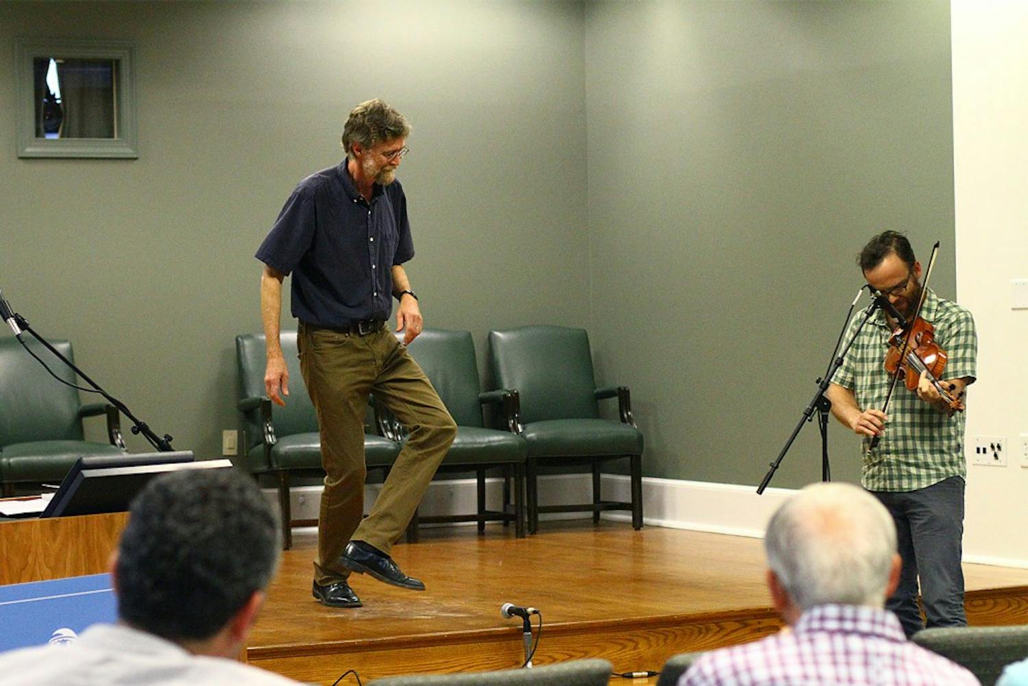 Phil Jameson, a professor at Warren Wilson College, performs in front of an audience in Wilson Library. He recently published the book "Hoedowns, Reels, and Frolics: Roots and Branches of Southern Appalachian Dance." 