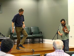 Phil Jameson, a professor at Warren Wilson College, performs in front of an audience in Wilson Library. He recently published the book "Hoedowns, Reels, and Frolics: Roots and Branches of Southern Appalachian Dance." 