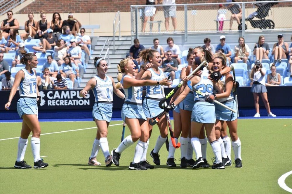 The North Carolina field hockey team celebrates during its 5-1 win against No. 5 Michigan on Aug. 25 at Carolina Field Hockey Stadium.