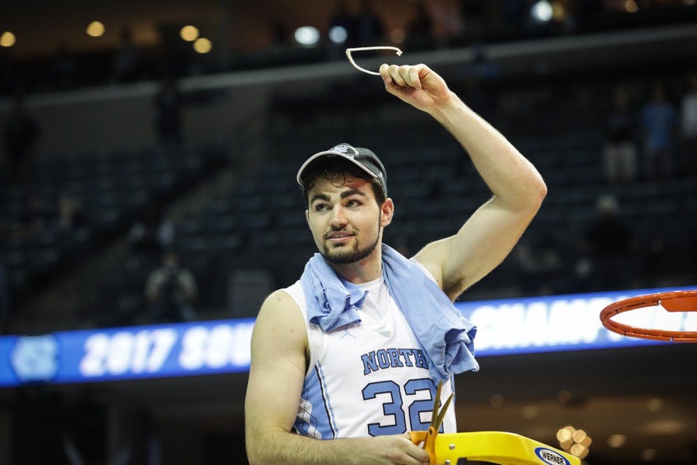 North Carolina forward Luke Maye (32) holds up a piece of the net after UNC's win over Kentucky in the NCAA Elite Eight game in Memphis on Sunday.