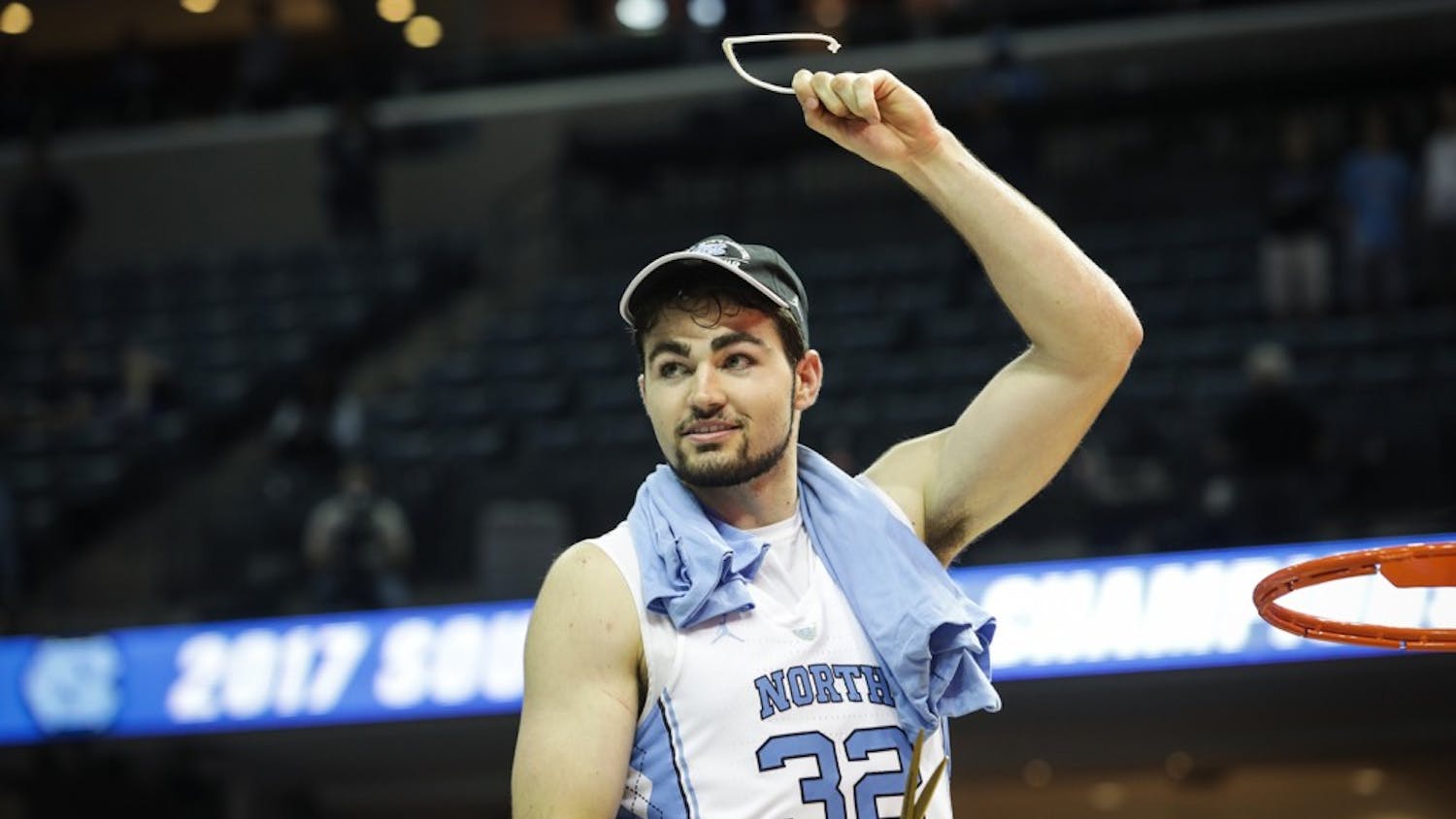 North Carolina forward Luke Maye (32) holds up a piece of the net after UNC's win over Kentucky in the NCAA Elite Eight game in Memphis on Sunday.