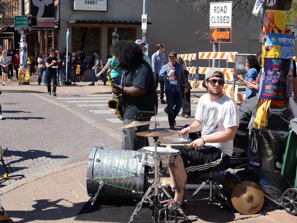 	Street performers on 6th Street in Austin, Texas during the 2014 South By Southwest Music Festival
