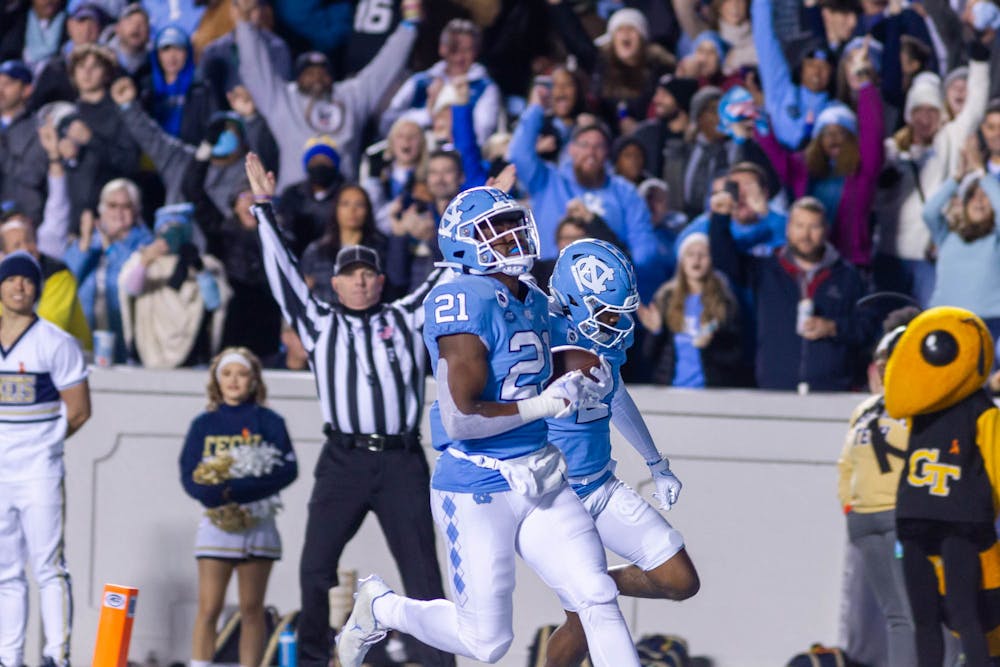 <p>UNC sophomore running back, Elijah Green (21), runs toward the end zone to score the first touchdown of the evening during the football game against Georgia Tech at Kenan Stadium on Saturday, Nov. 19, 2022.</p>