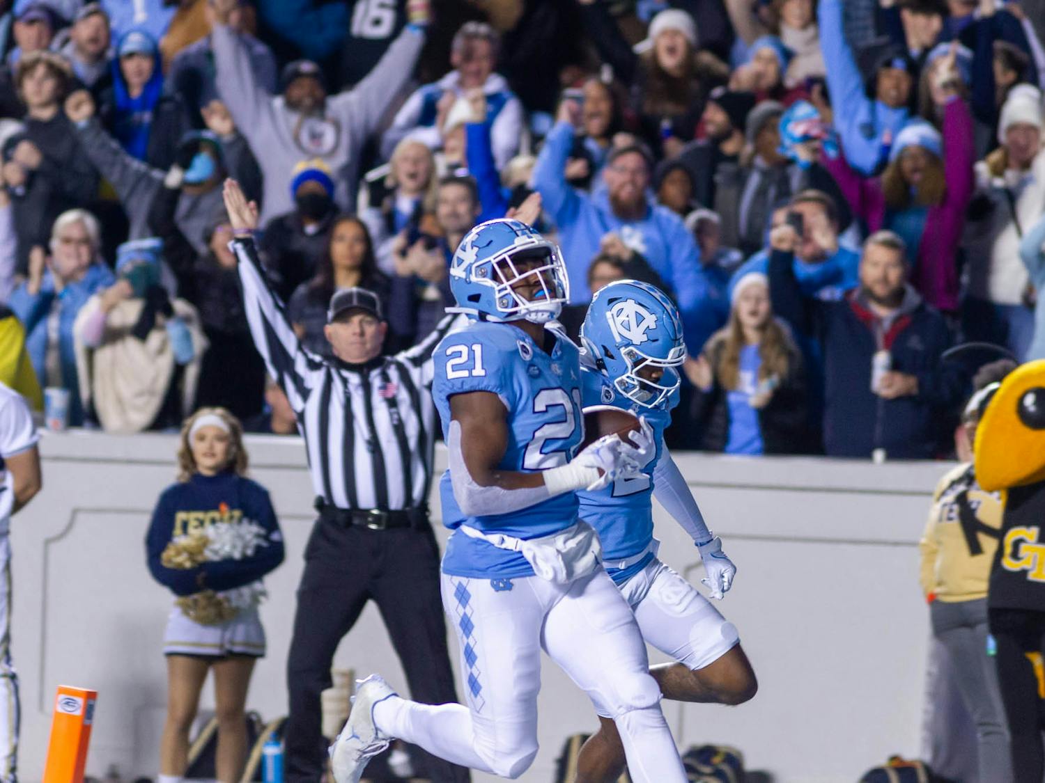 UNC sophomore running back, Elijah Green (21), runs toward the end zone to score the first touchdown of the evening during the football game against Georgia Tech at Kenan Stadium on Saturday, Nov. 19, 2022.