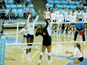 Sophomore opposite and outside hitter Destiny Cox (1) and junior middle blocker Aristea Tontai (3) team up for a block attempt against Miami's Janet Kalaniuvalu (6) on Friday, Oct. 11, 2019 in Carmichael Arena. UNC beat Miami 3-1.&nbsp;