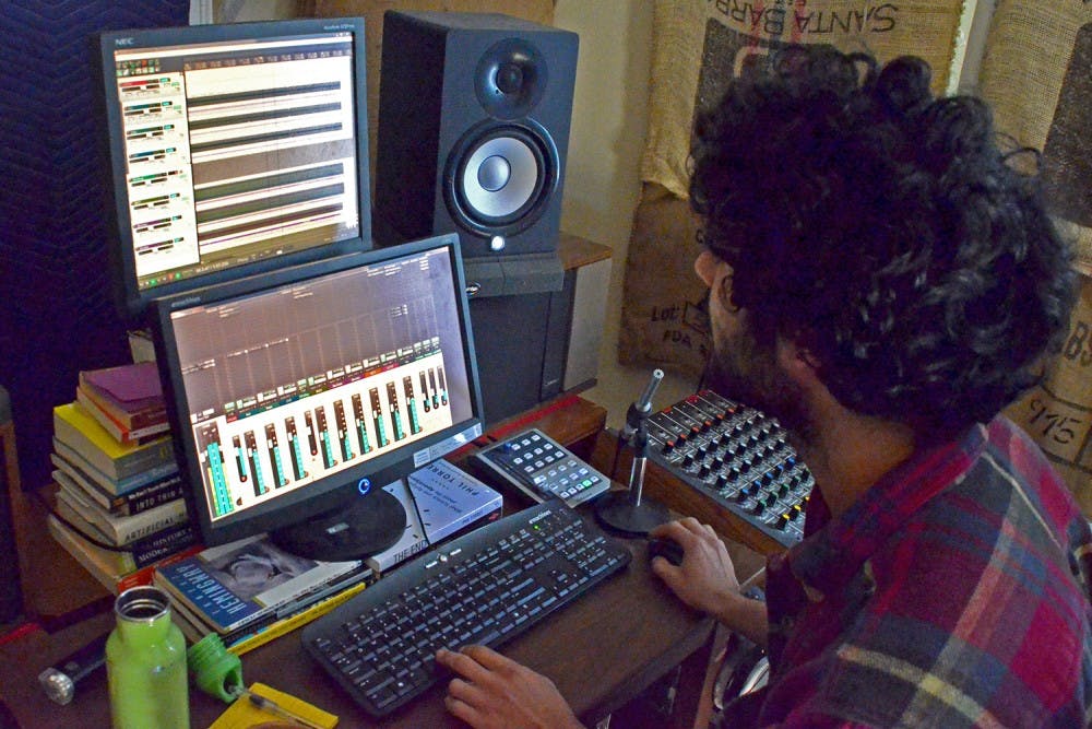 Owner Saman Khoujinian mixes sound in the control room at Sleepy Cat Studios in Carrboro.