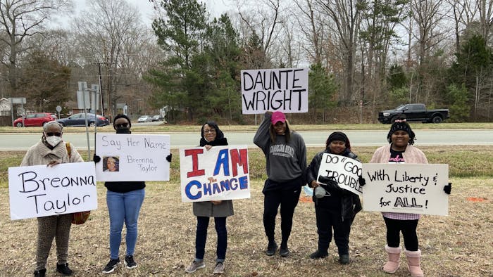 Members and advisors of the Chapel Hill Carrboro Youth Council pose with their signs that convey anti-racist messages on Feb. 26, 2022 beside Highway 15-501, the highway next to Binkley Baptist Church. They have shown up for vigils regularly since May of 2020. 