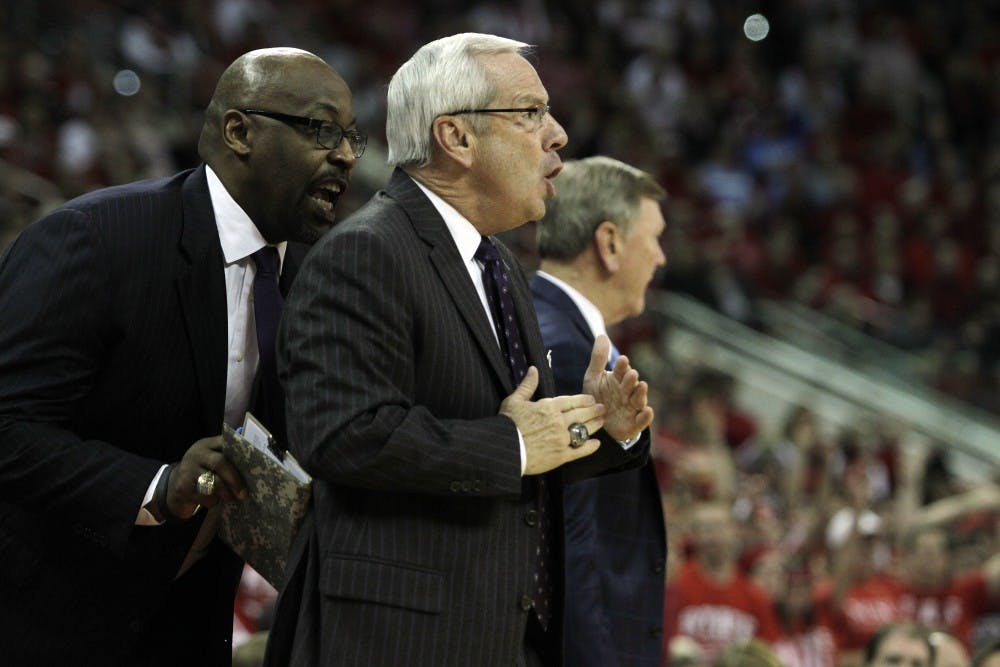 	<p>Coach Roy Williams and Coach Steve Robinson shout at the <span class="caps">UNC</span> players and referees during the N.C. State game Saturday night.</p>