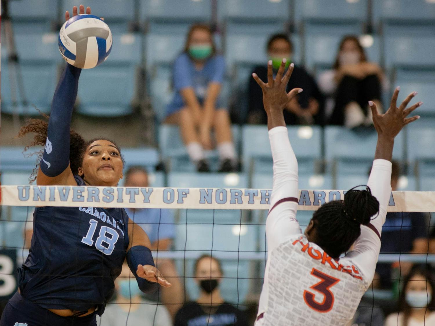 Graduate outside hitter Nia Robinson (18) spikes the ball in the UNC Women's volleyball game against Virginia Tech at the Woolen Gymnasium on Oct. 10. The Heels won 3-0.