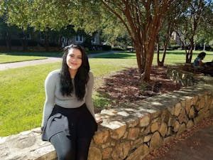 Jamie Ramos, a senior information science major and first-generation student, sits on the quad near Manly and Mangum. Photo courtesy of Mohamed Lansari.