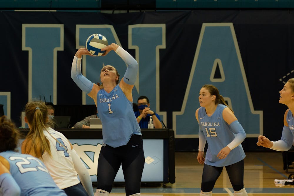 UNC graduate setter Meghan Neelon (1) sets the ball during a home volleyball game against the University of Virginia on Sept. 26 in Carmichael Arena.