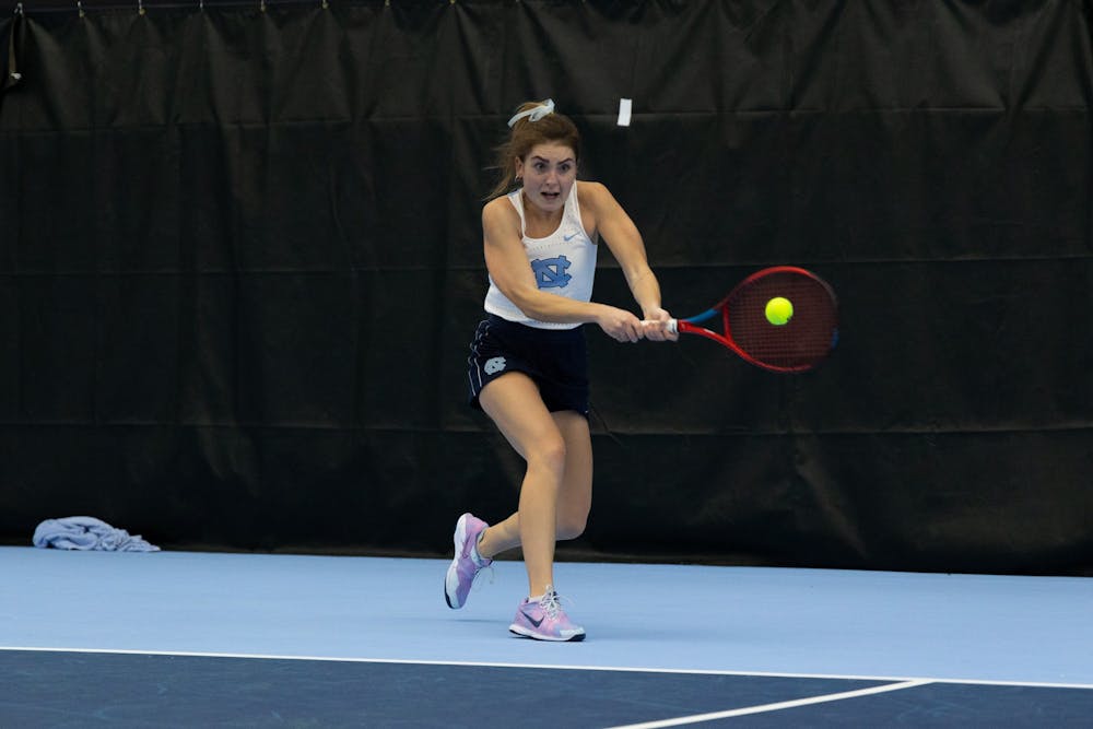 Junior Fiona Crawley returns the ball during her singles match against Elon University at the Cone-Kenfield Tennis Center on  Friday, January 13, 2023. UNC beat Elon 4-2.