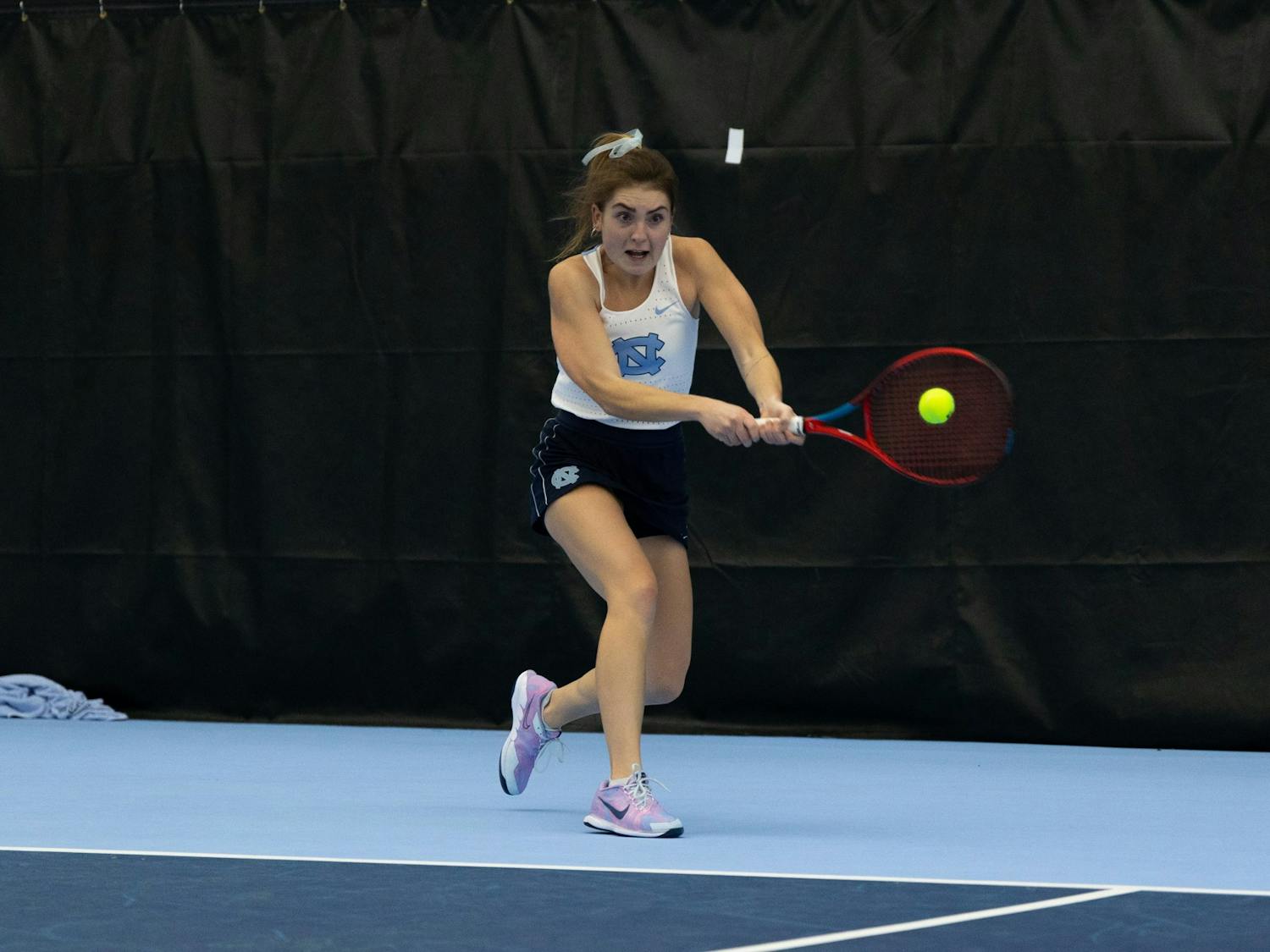 Junior Fiona Crawley returns the ball during her singles match against Elon University at the Cone-Kenfield Tennis Center on  Friday, January 13, 2023. UNC beat Elon 4-2.