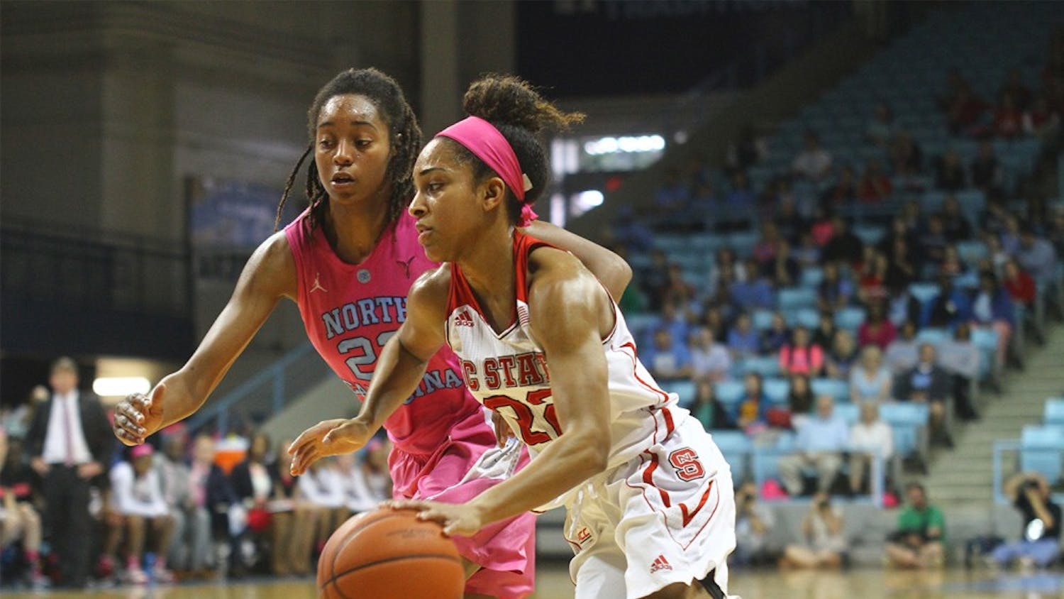 Senior guard N’Dea Bryant (22) defends Dominique  Wilson (right) during the game against NC State on Sunday.