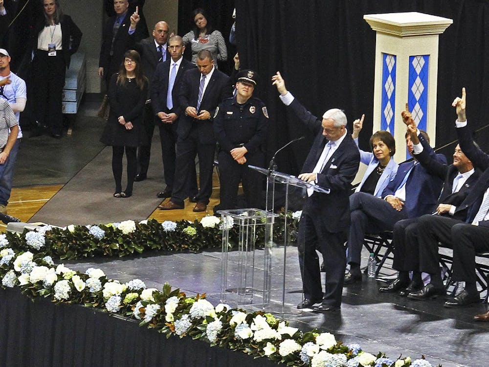 Roy Williams honors Dean Smith's legendary concept of pointing to the passer during the memorial service for Smith on Sunday in the Smith Center.