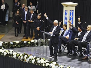 Roy Williams honors Dean Smith's legendary concept of pointing to the passer during the memorial service for Smith on Sunday in the Smith Center.