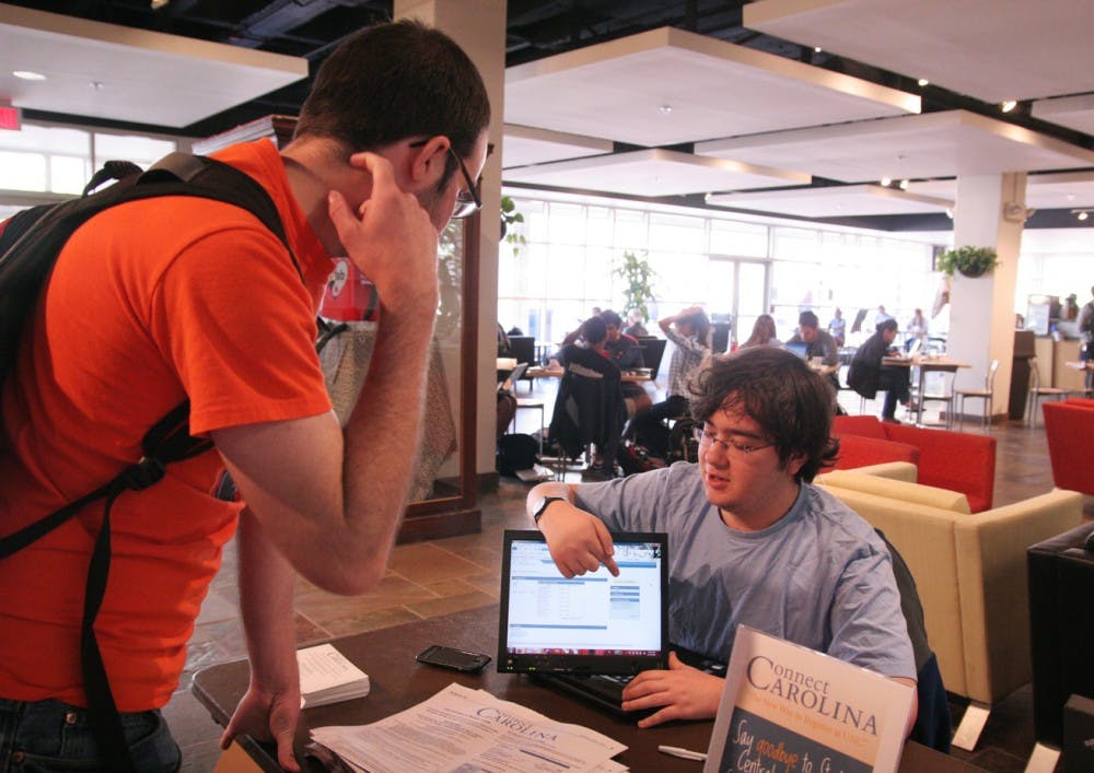 Junior Max Beckman-Harned, right, answers sophomore Stephen Wiley’s questions about his registration status.