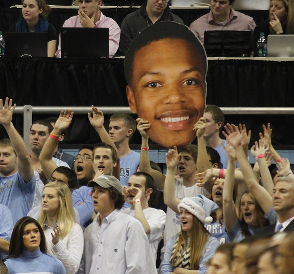 	Students in the riser section hold a cut out of UNC freshman Nate Britt (0) againt Texas on Dec. 18.