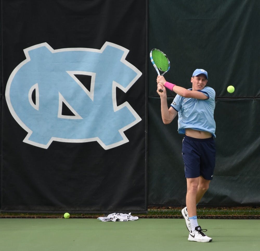 North Carolina men's tennis player Blaine Boyden takes a backhand.