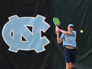 North Carolina men's tennis player Blaine Boyden takes a backhand.