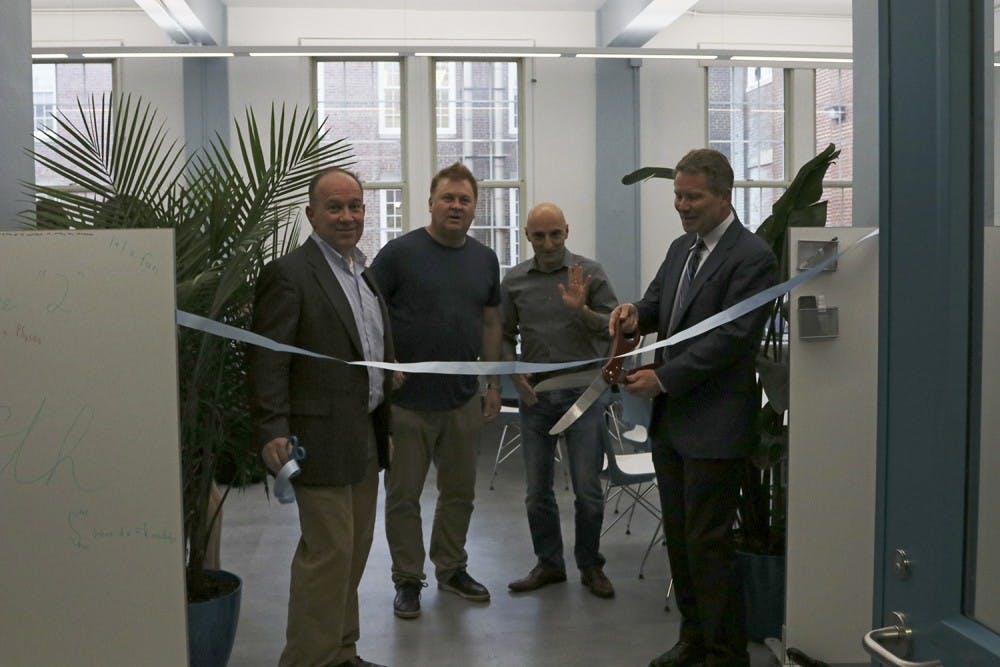 Christopher Clemens (left), Richard McLaughlin, Christian Iliadis, Kevin Guskiewicz cut the ribbon for the grand opening of the Physics and Math Center in Phillips Hall.&nbsp;