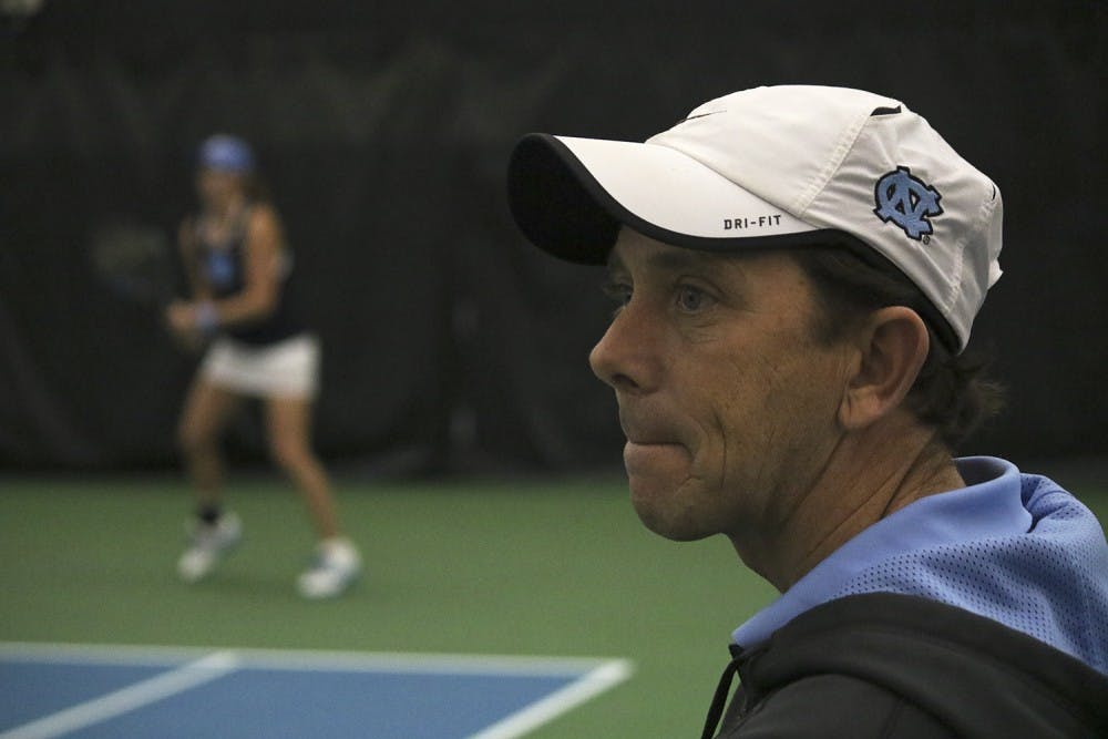 North Carolina women's tennis head coach Brian Kalbas watches as his team beats Texas A&M 4-0.