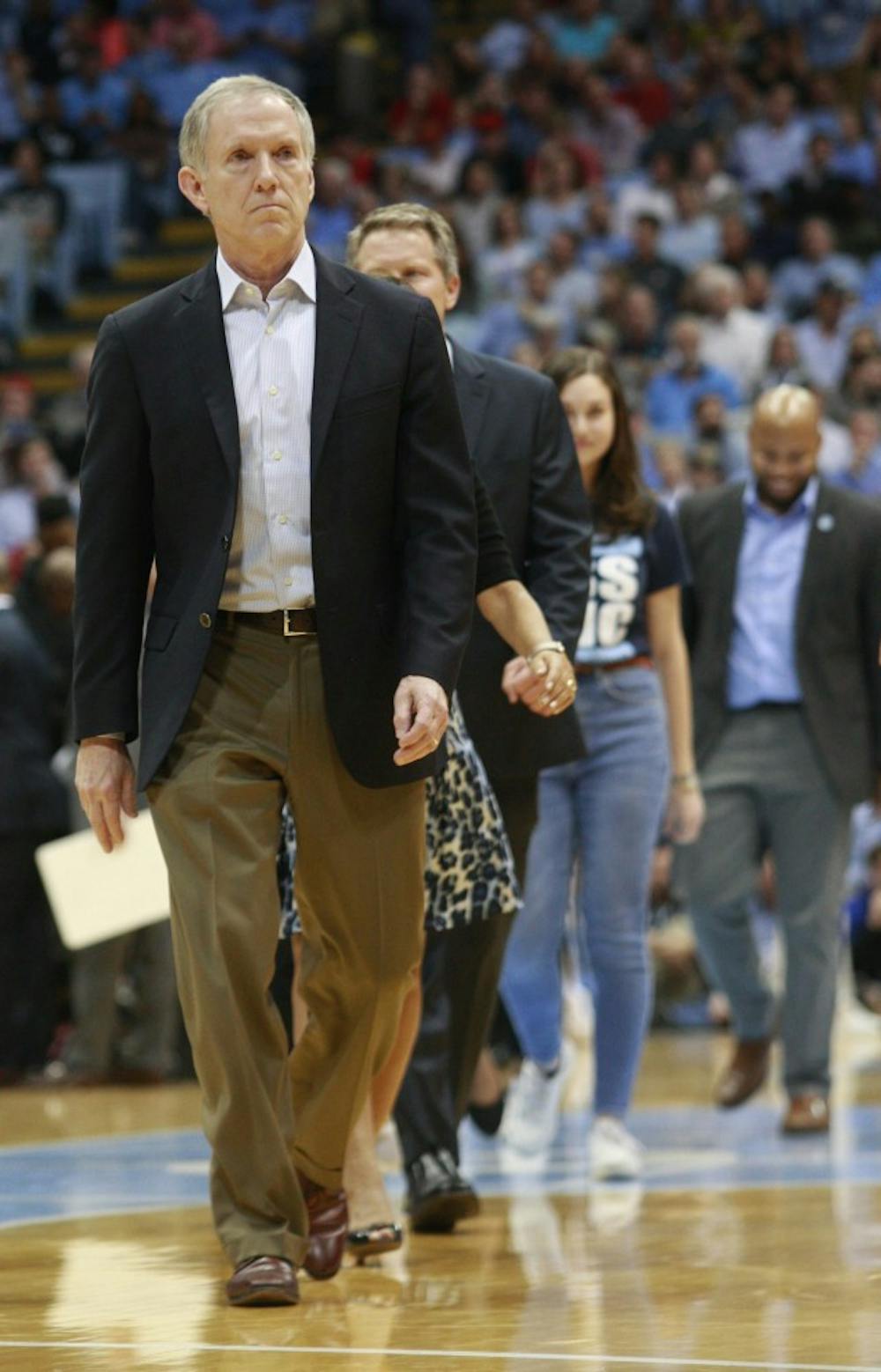 Chapel Hill alumnus William McLean leads Chancellor Folt and Science Scholas after speaking about the initiative during halftime of the Men's Basketball game at UNC versus N.C. State at the Smith Center on Tuesday, Feb. 5, 2019. 