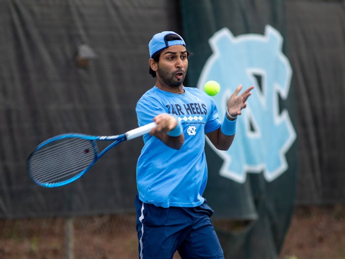 Junior Anuj Watane hits the ball during UNC's match against Louisville at the Chapel Hill Tennis Club on March 25th, 2022. UNC won 4-1.