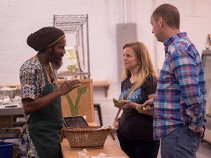 Yah-i Amen, one of the founders and owners of Vegan Flava Cafe, engages with guests at the Blue Dogwood location soon to open to the public.