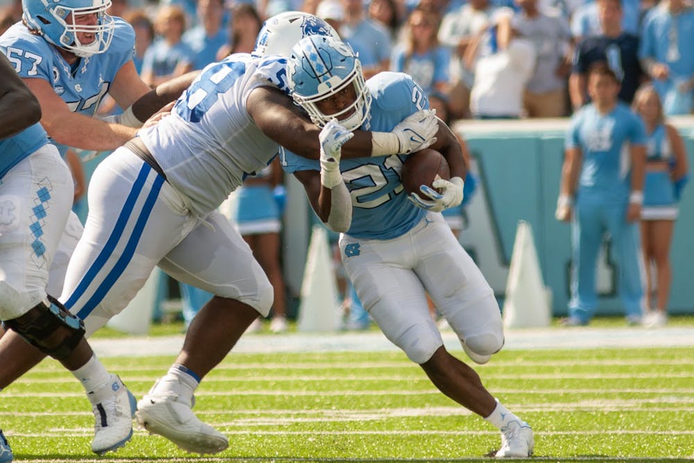 Redshirt first-year Elijah Green (21) runs with the ball at the game against Duke on Oct. 2 at Kenan Stadium. UNC won 38-7.