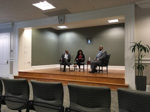 Student Body President Ashton Martin (center) asks UNC Police Chief candidate David Perry (right) a question at a Q&amp;A in the Wilson Library