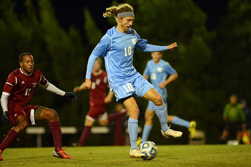 UNC Junior Andy Craven (10) passes the ball.