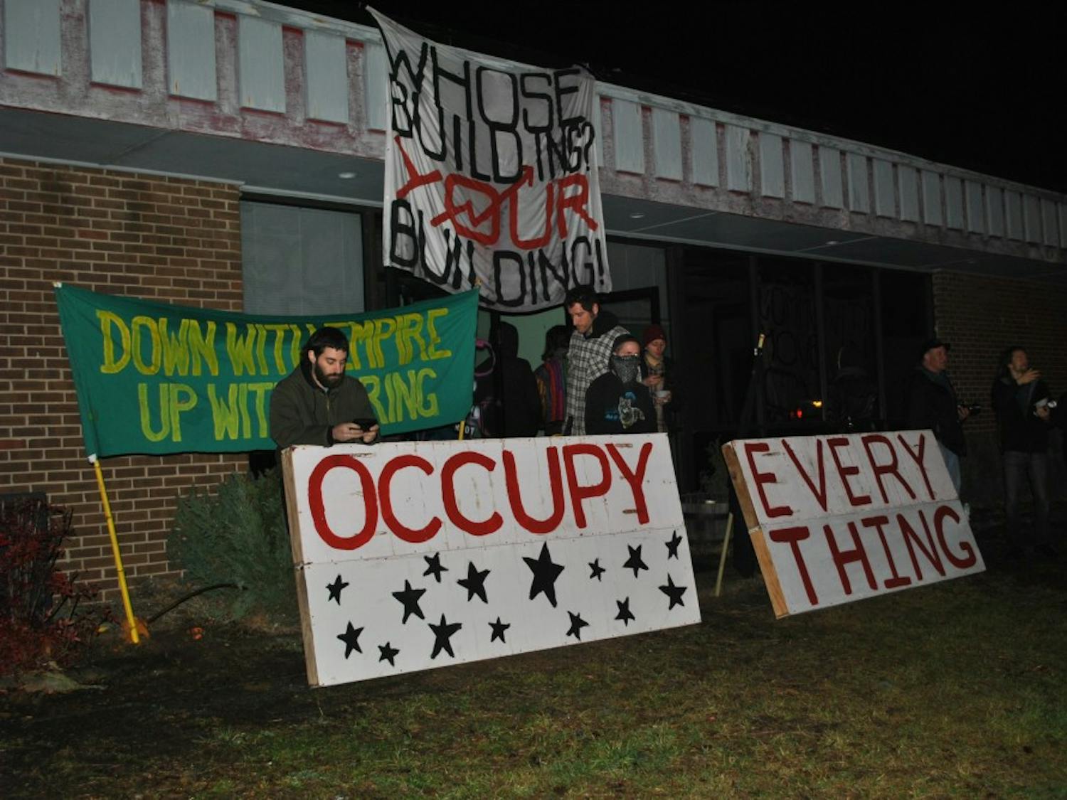	A group of protesters with the Carrboro Commune group gather outside of the encampment of a formerly vacant building at 201 N. Greensboro St., the planned site of a CVS. 