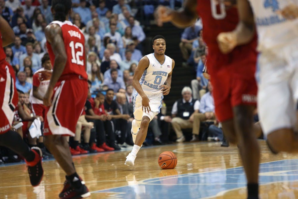 Guard Nate Britt (0) brings the ball to the top of the key.&nbsp;