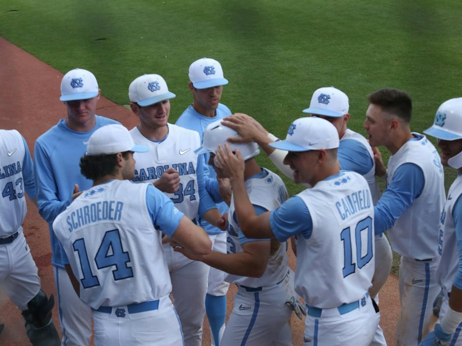 The Tar Heels' baseball team celebrates another run during their third baseball game against Boston College on Easter weekend, 2019.
