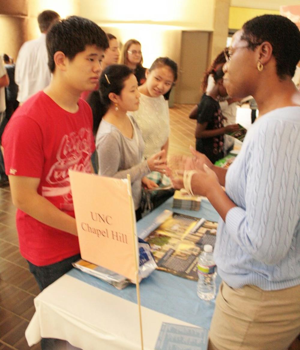 Jason Son, 17, talks to Kendra Lawrence, an assistant director at the Office of Undergraduate Admissions at the CCHCS College Fair.  Jason hopes to attend UNC-Chapel Hill.