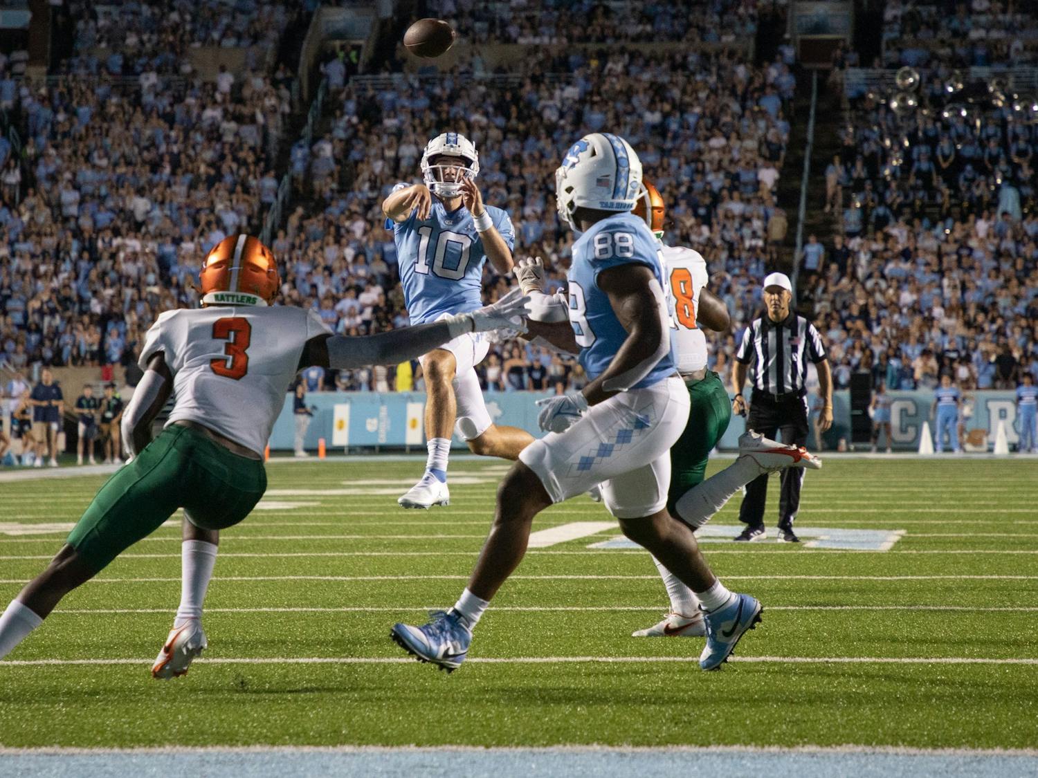 Freshman quarterback Drake Maye (10) throws the ball to graduate student tight end Kamari Morales (88) for a touchdown during UNC's opening game against Florida A&M at Kenan Stadium on Aug. 27, 2022. UNC won 56-24.