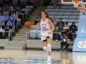 Redshirt Junior Eva Hodgson (10) takes the ball down the court at the game against James Madison University on Dec. 5, 2021 at Carmichael Arena. The Tar Heels won 93-47.