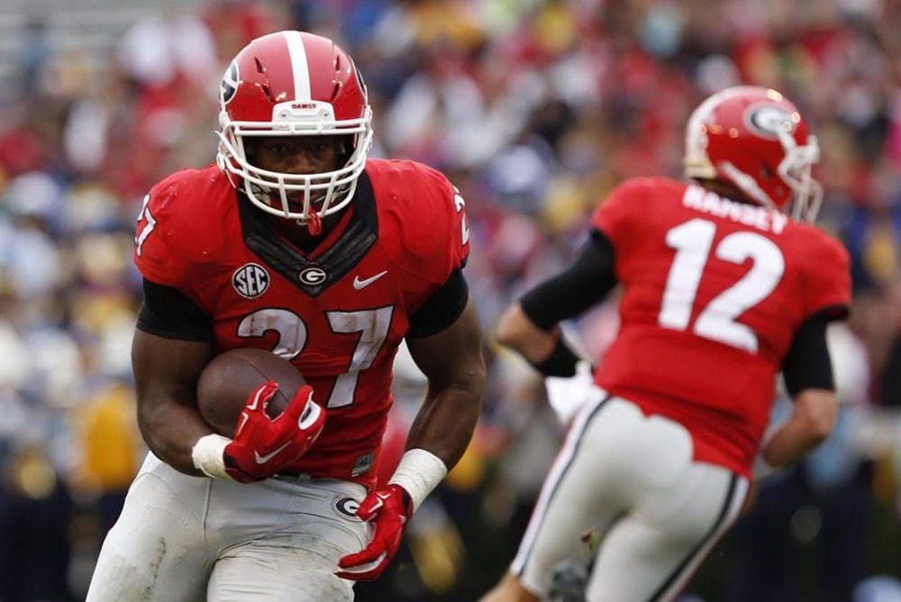 Georgia running back, Nick Chubb (27) turns to carry the ball upfield after receiving a handoff. Photo Courtesy of Joshua L. Jones of&nbsp;The Red and Black.&nbsp;
